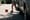 Girl running into the street chasing a ball next to parked cars.